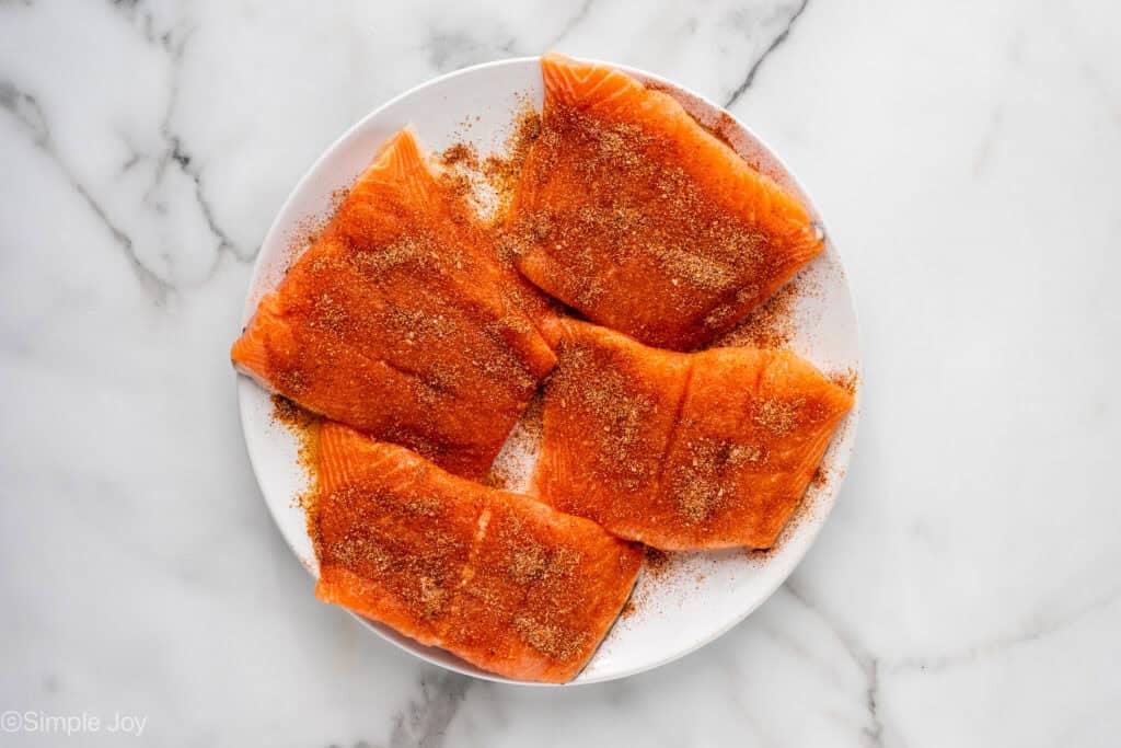 Overhead of plate of raw salmon that has been seasoned