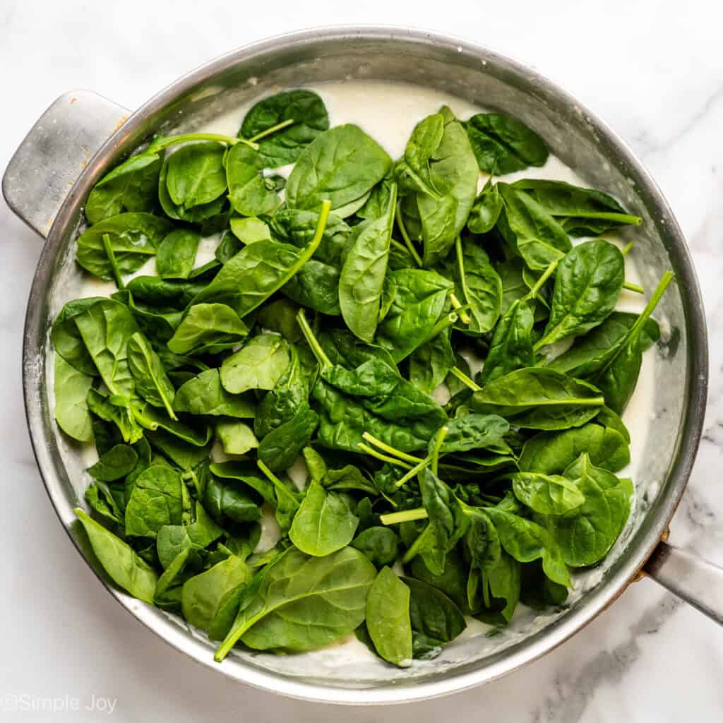 Overhead of skillet full of fresh spinach