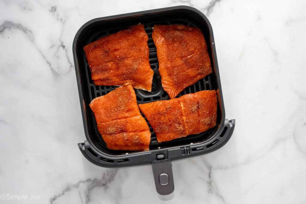 Overhead of raw salmon in air fryer basket