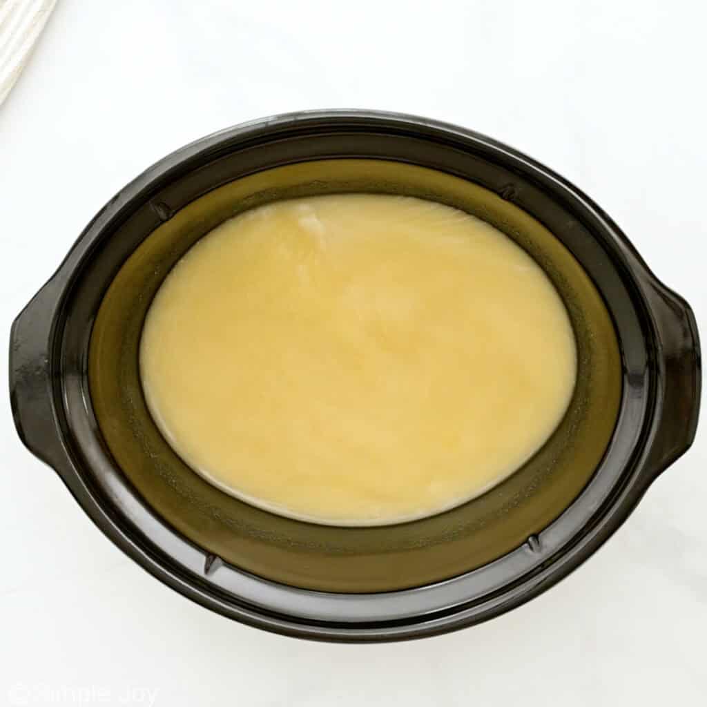 Overhead of slow cooker of broth and masa harina