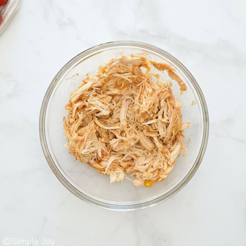 Overhead of bowl of shredded chicken